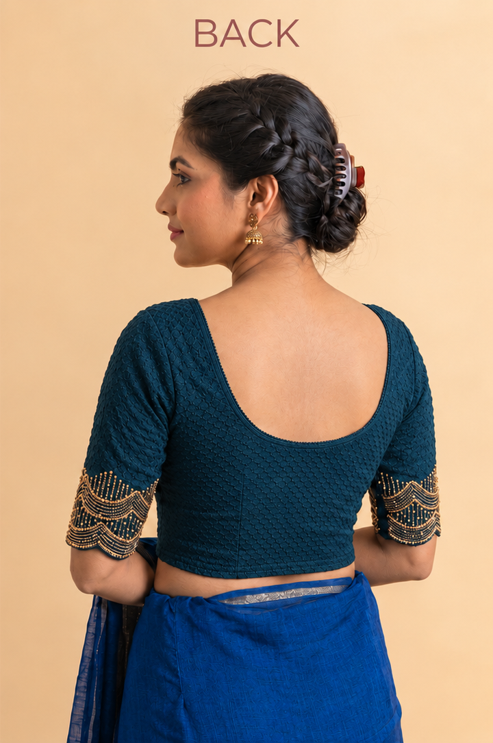 Back of dark teal stretchable blouse with a deep scoop back and gold-trimmed sleeves