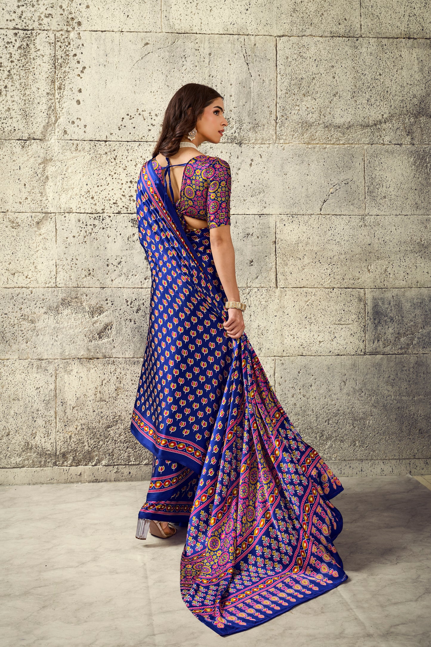 Cobalt blue saree with short sleeves, multicolor geometric border and draped pleats
