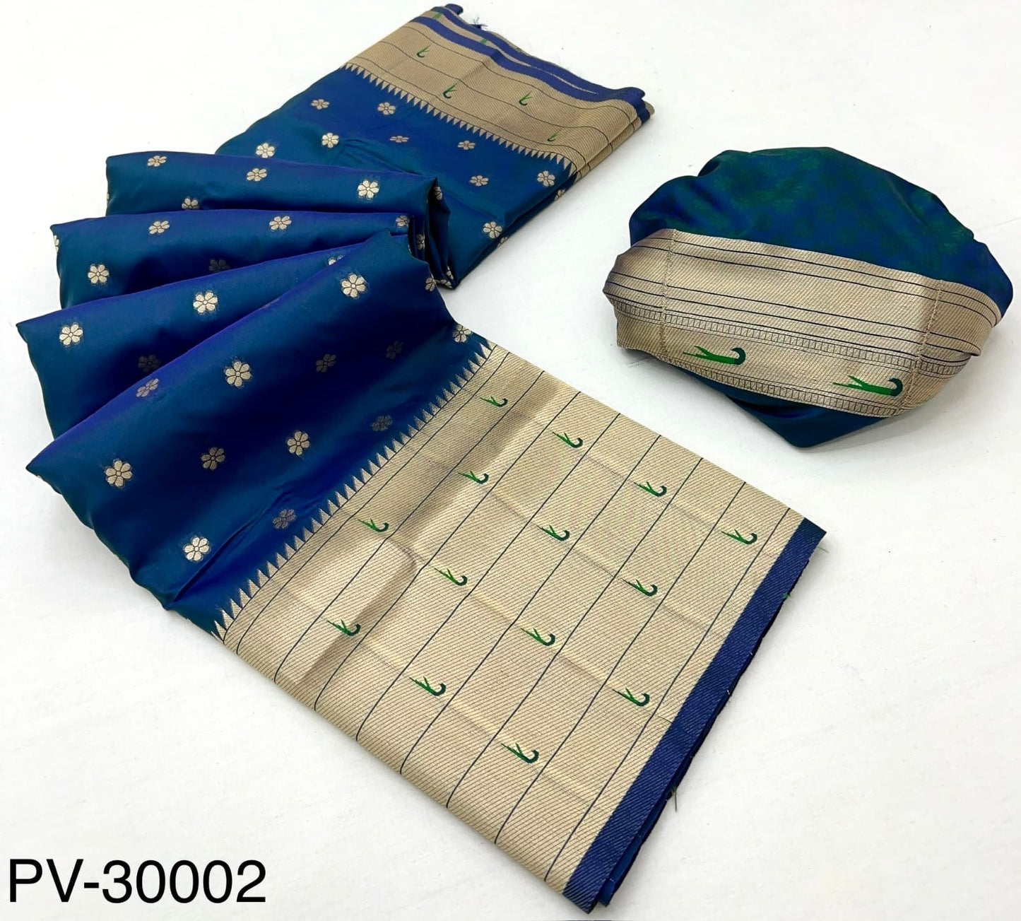 Folded blue and beige silk saree fabric with gold motifs and woven striped border