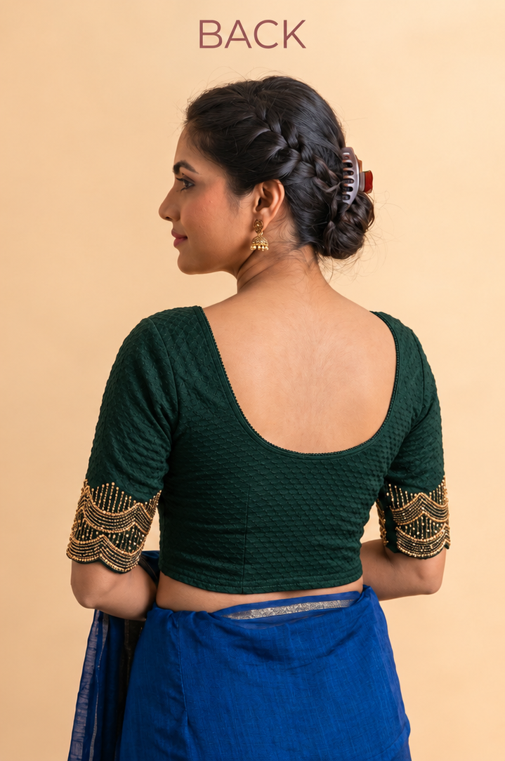Back view of bottle green stretch blouse with a deep scoop back and gold sleeve trim