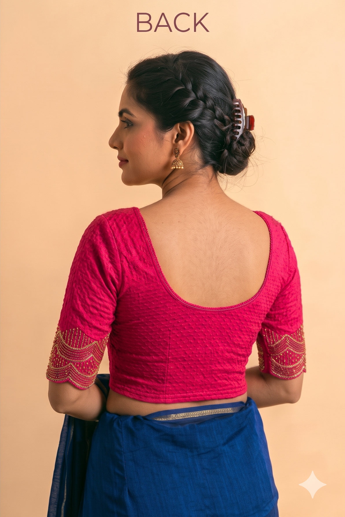 Pink stretch blouse with a low scoop back and short sleeves with gold-patterned cuffs