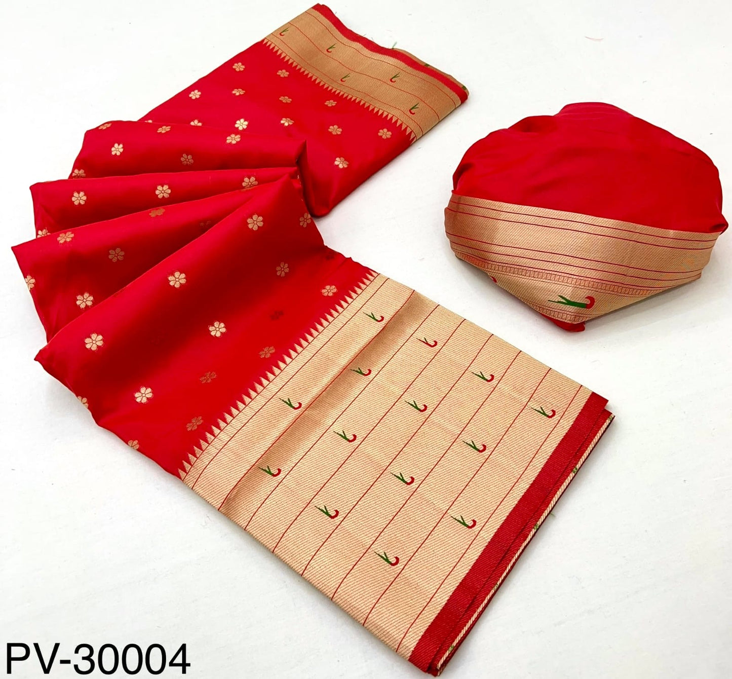 Folded red saree with beige patterned border and matching fabric pouch