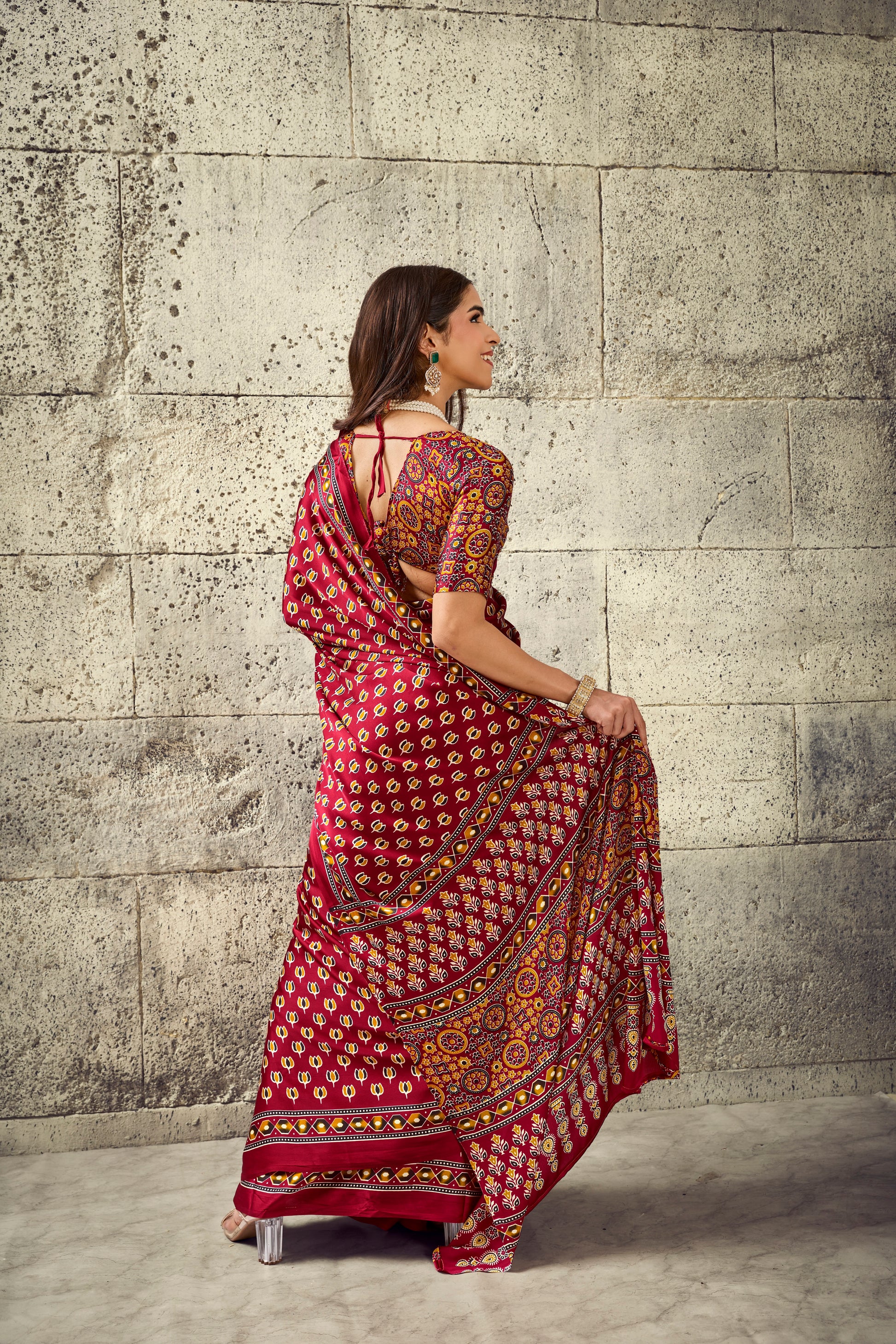 Red printed ready-to-wear saree with decorative border, side drape view
