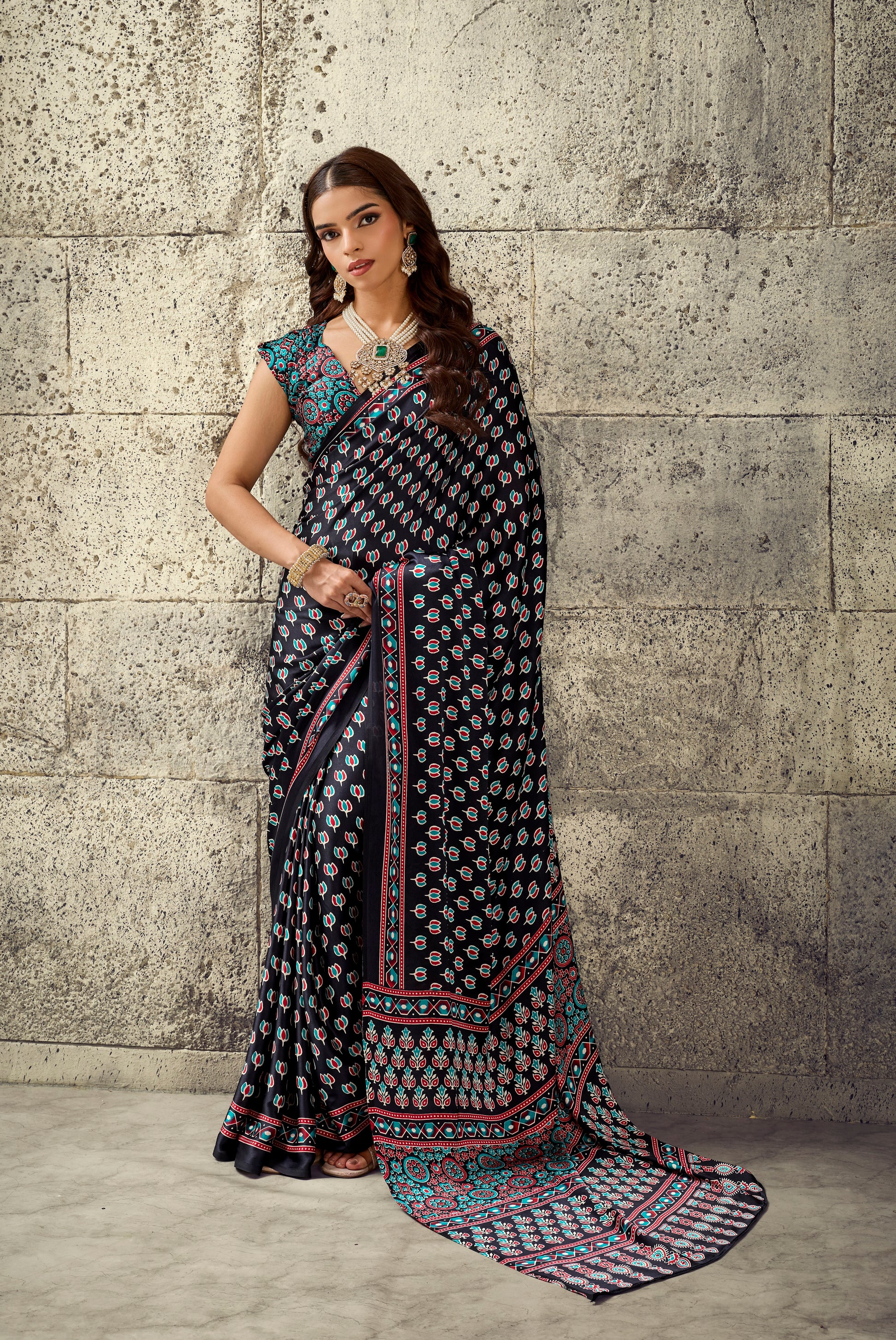 Dark printed ready-to-wear saree with sleeveless blouse, ornate turquoise border and hem