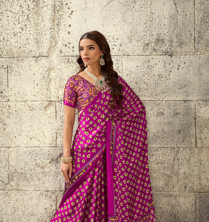Magenta saree with short sleeves and intricate allover motifs, drape with gold trim