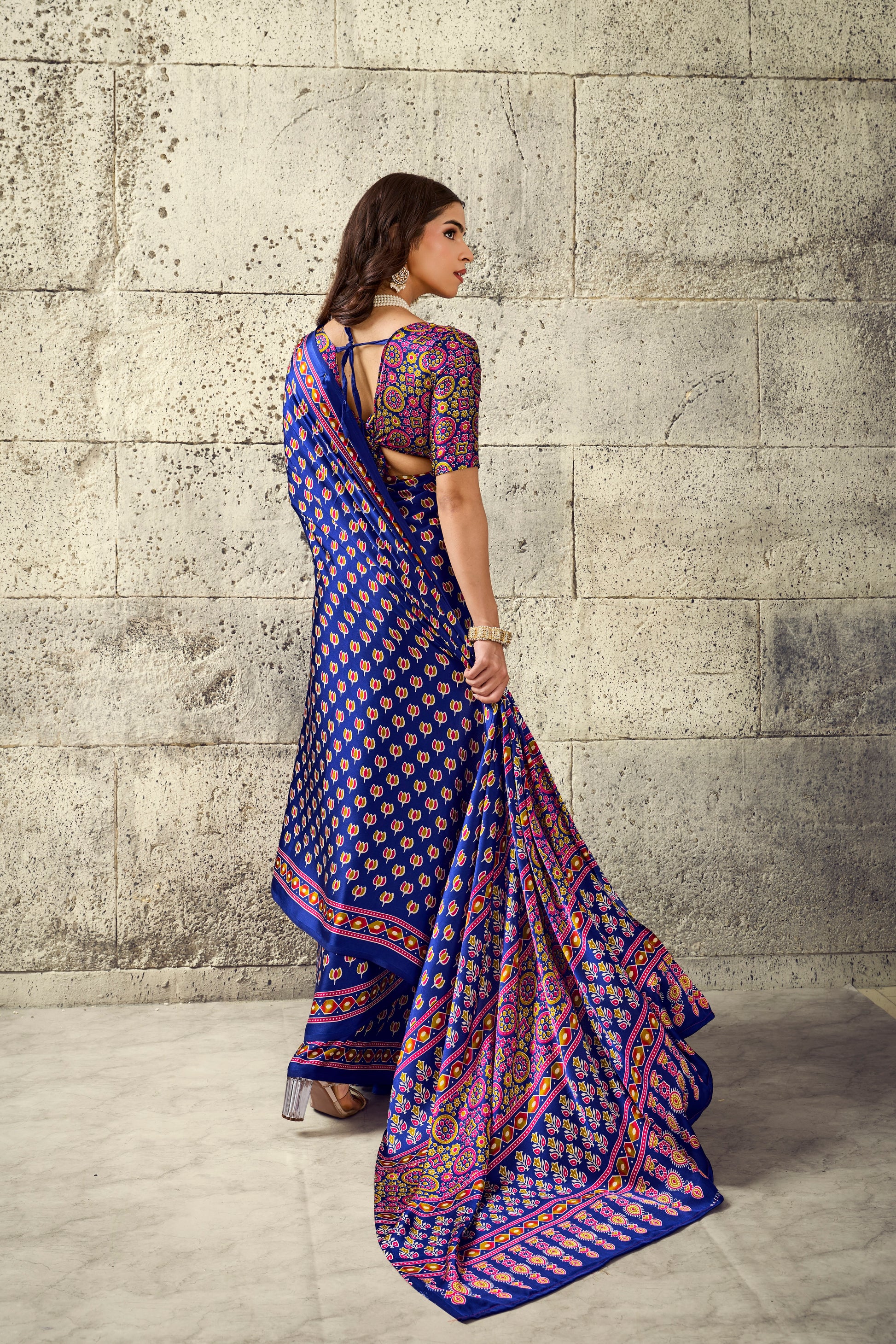 Cobalt blue saree with short sleeves, multicolor geometric border and draped pleats