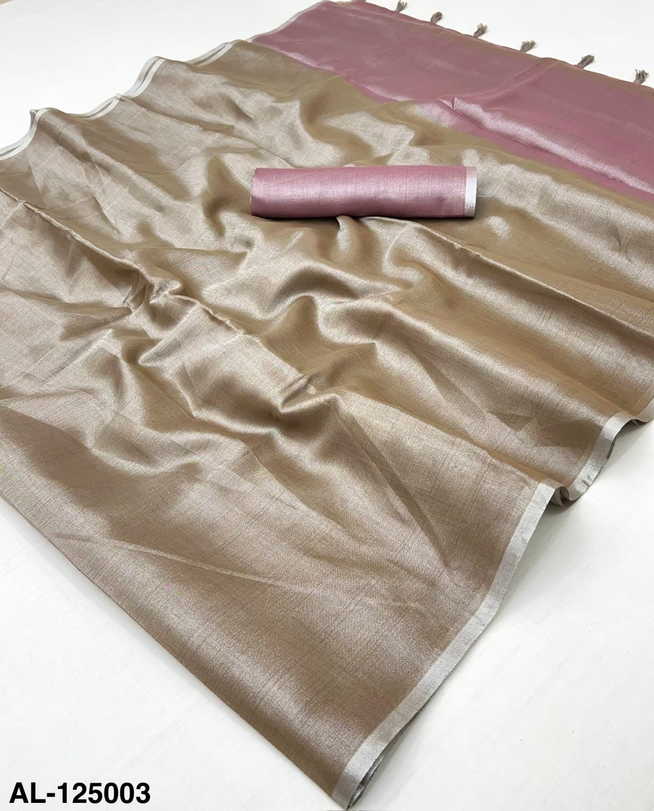 Bronze tissue silk saree fabric with pink border, flat lay with rolled end