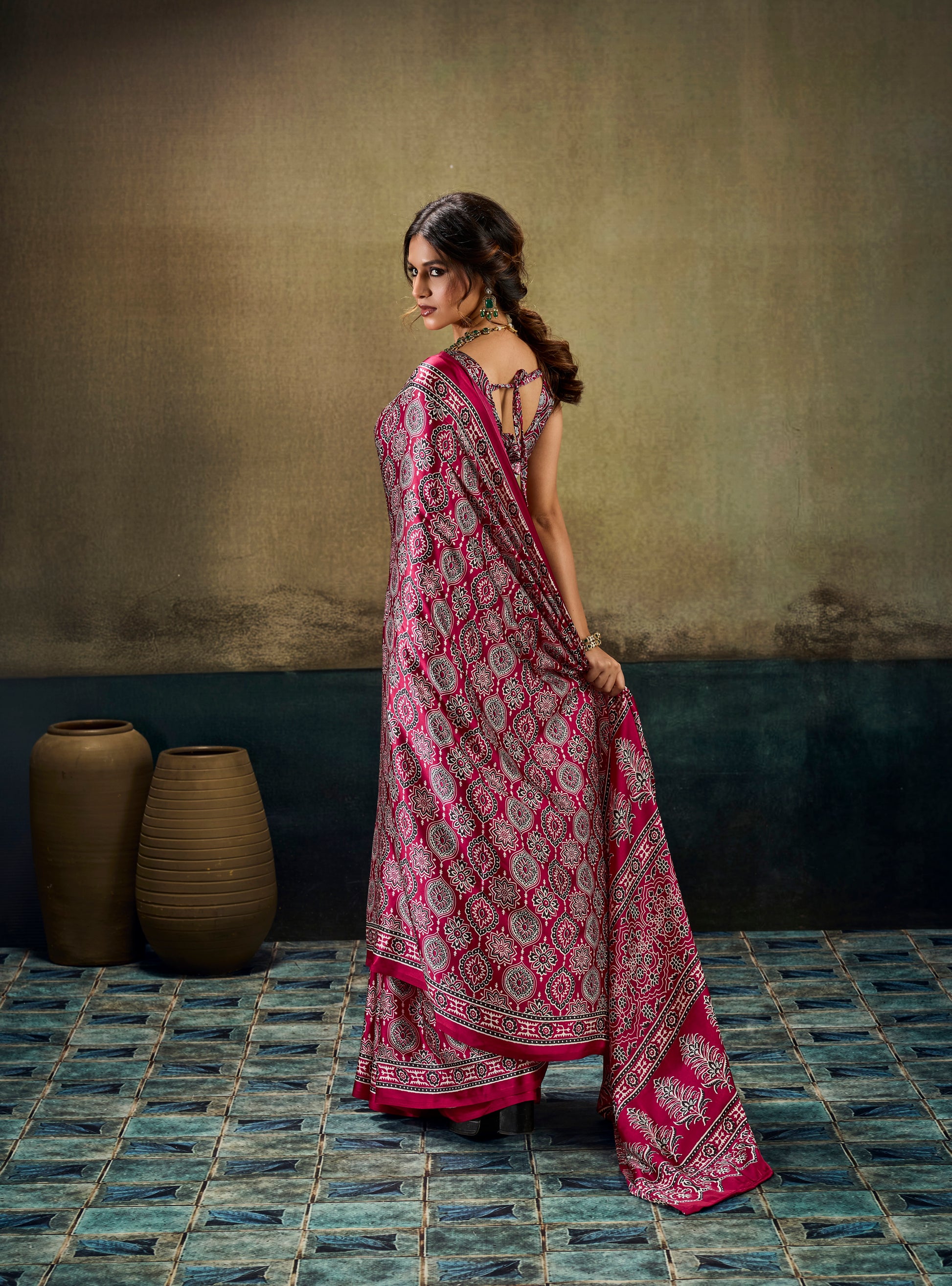 Dark pink printed modal-silk ready-to-wear saree draped over shoulder, border hem