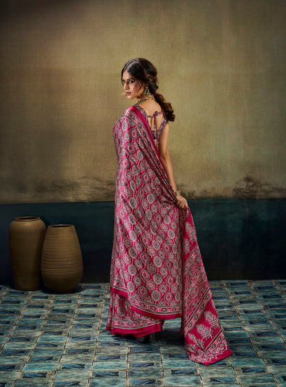 Dark pink printed modal-silk ready-to-wear saree draped over shoulder, border hem