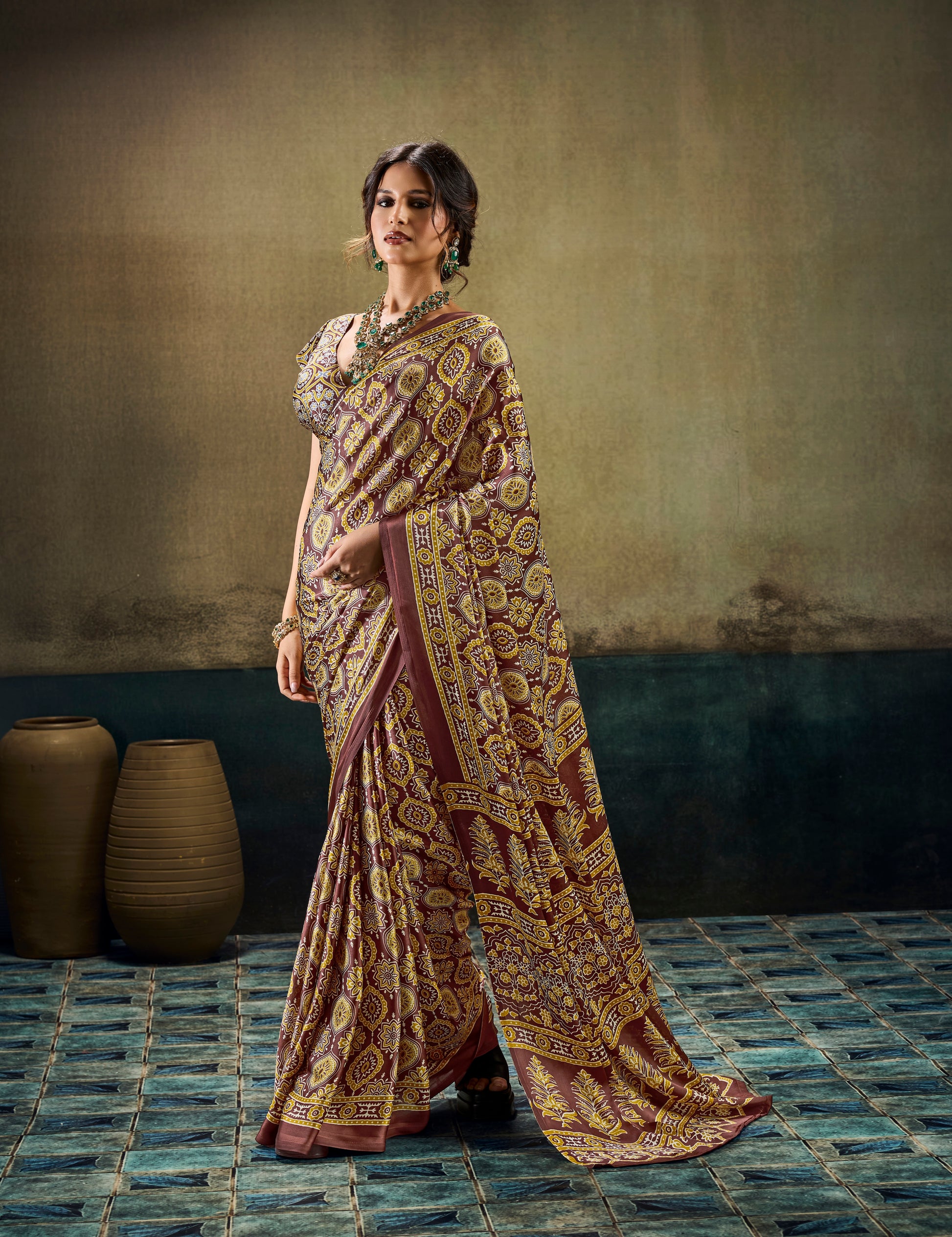 Brown printed saree with short sleeves, gold-toned motifs, and wide border