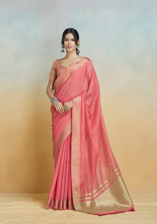 Coral pink khadi silk saree with gold border and draped pallu, full-length view