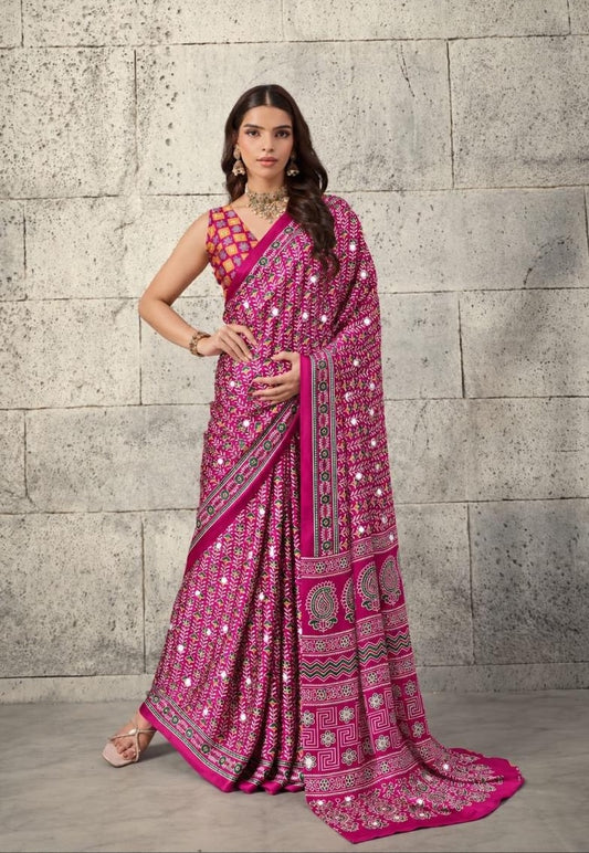 Fuchsia patterned saree with border detail and sleeveless mirrorwork blouse