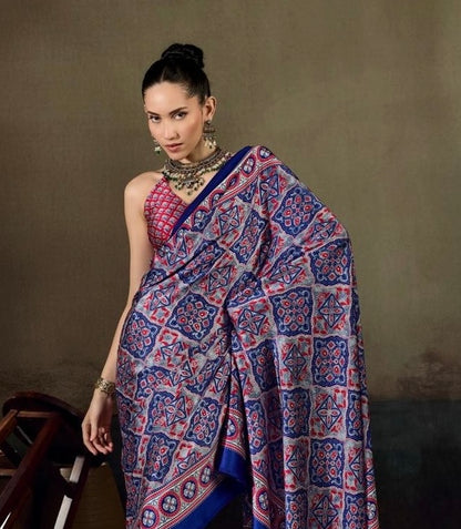 Blue printed saree with red motifs, draped pallu and border, ready-to-wear style