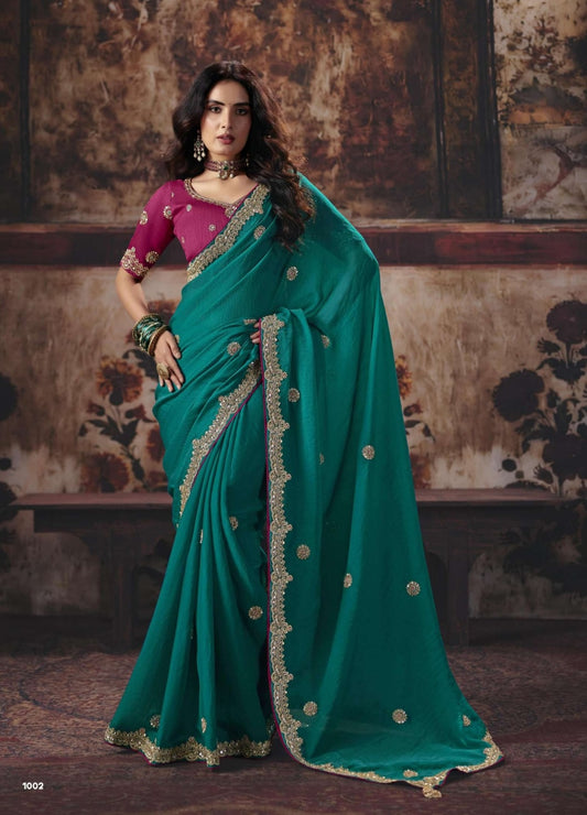 Teal green saree with gold border and round embellishments, paired with pink blouse