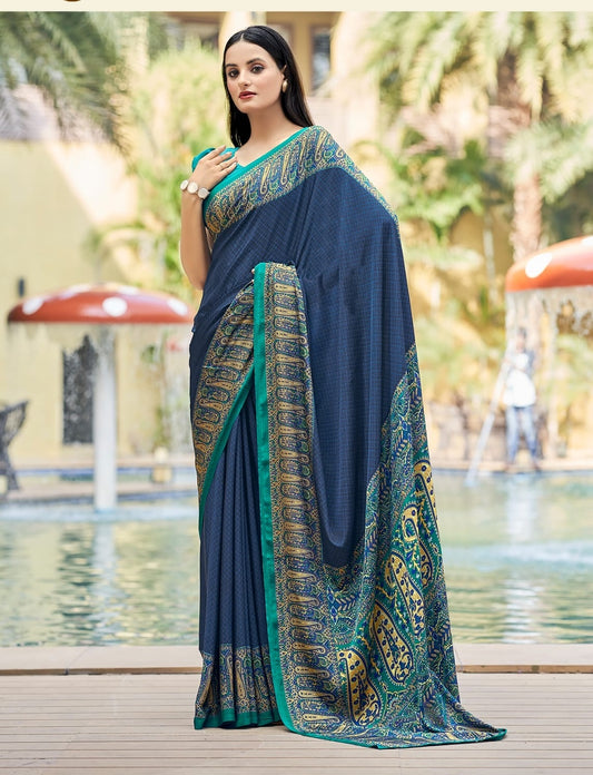 Navy crepe silk saree with teal-gold patterned border and draped pallu