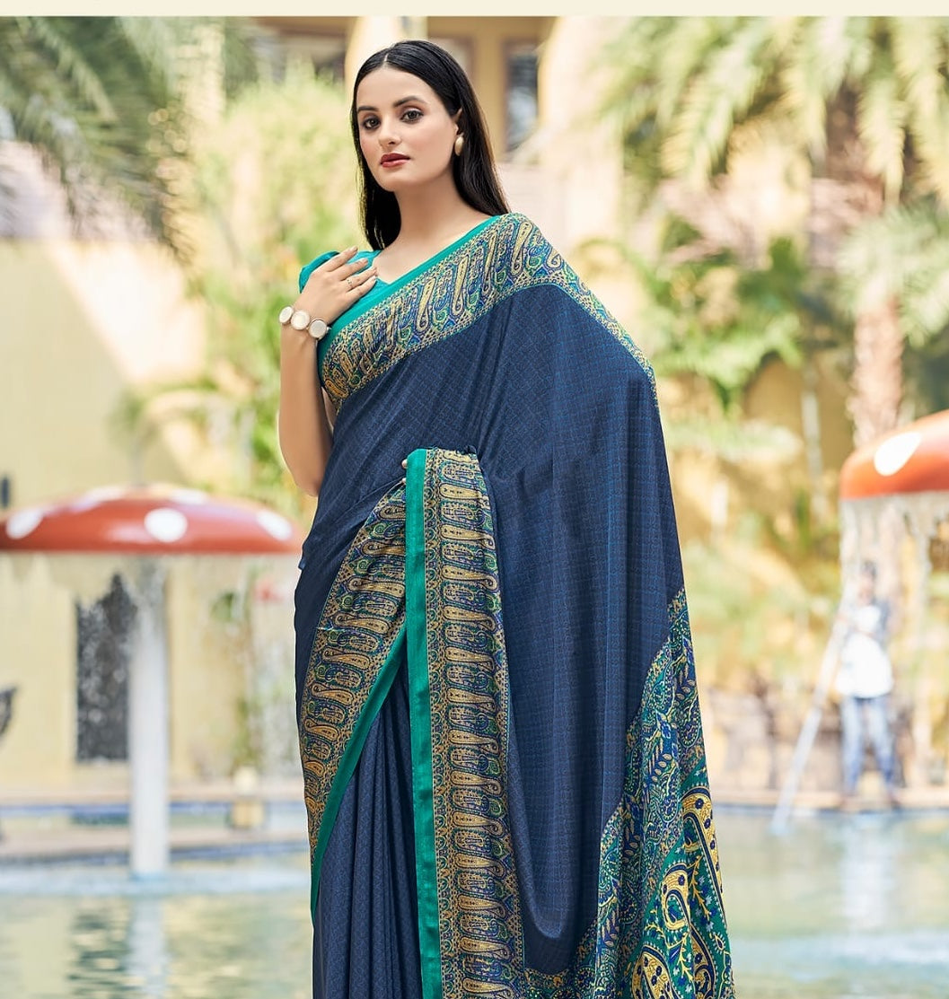 Navy crepe silk saree with teal patterned pallu and gold border detail