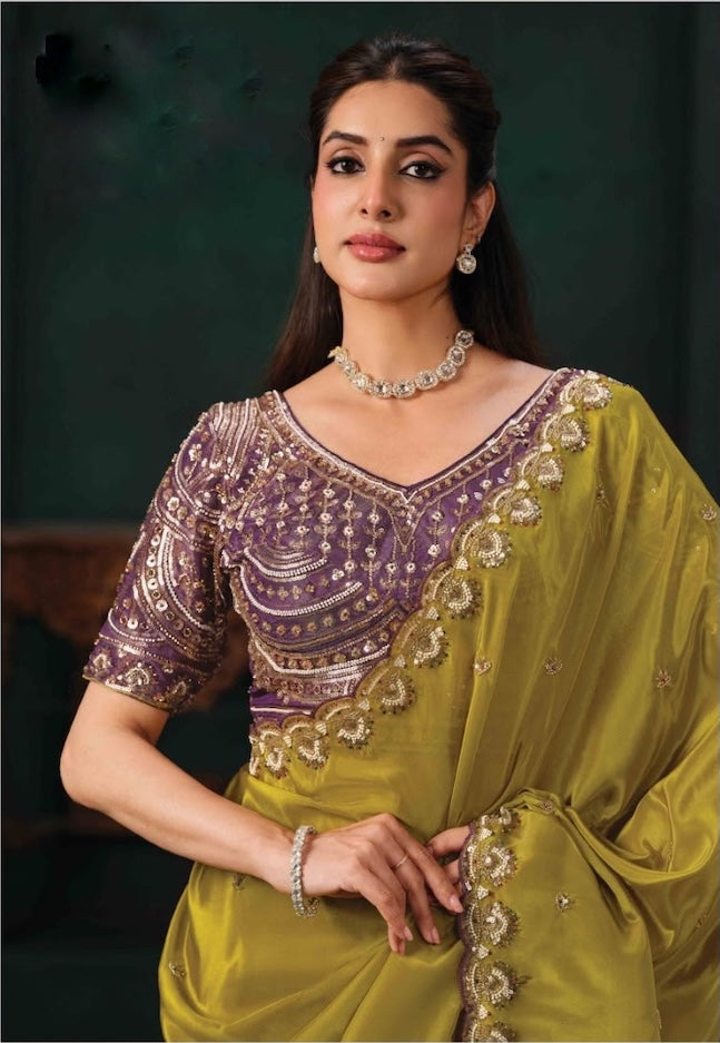 Olive green saree with a purple, gold-embroidered blouse and ornate border