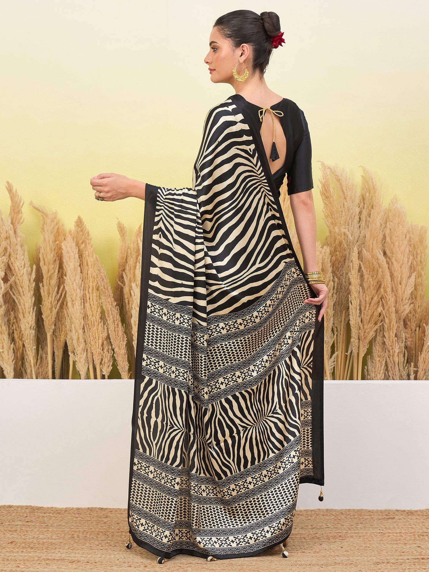 Black crepe silk easy saree with zebra stripes and patterned border, open-back blouse