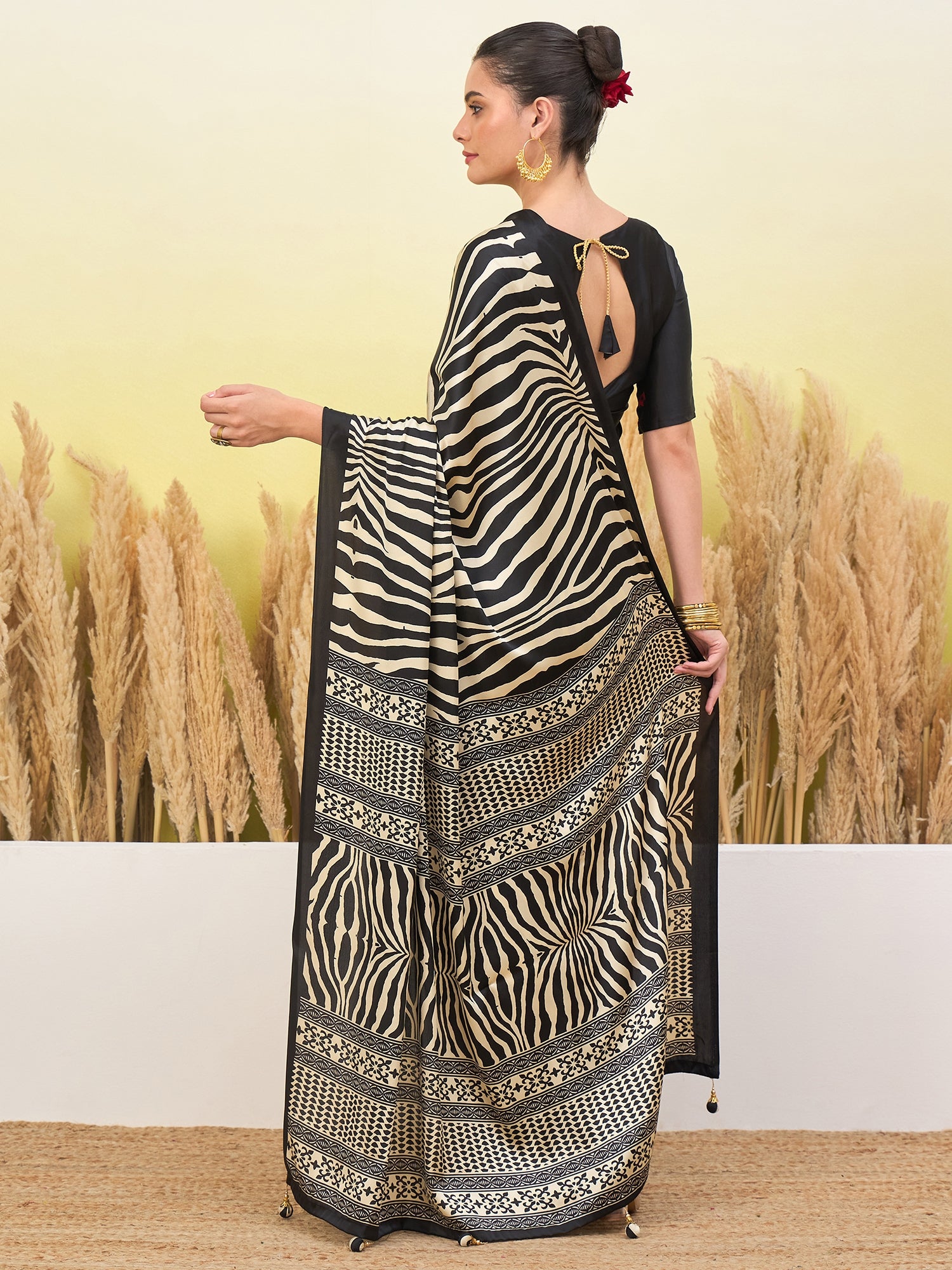 Black crepe silk easy saree with zebra stripes and patterned border, open-back blouse