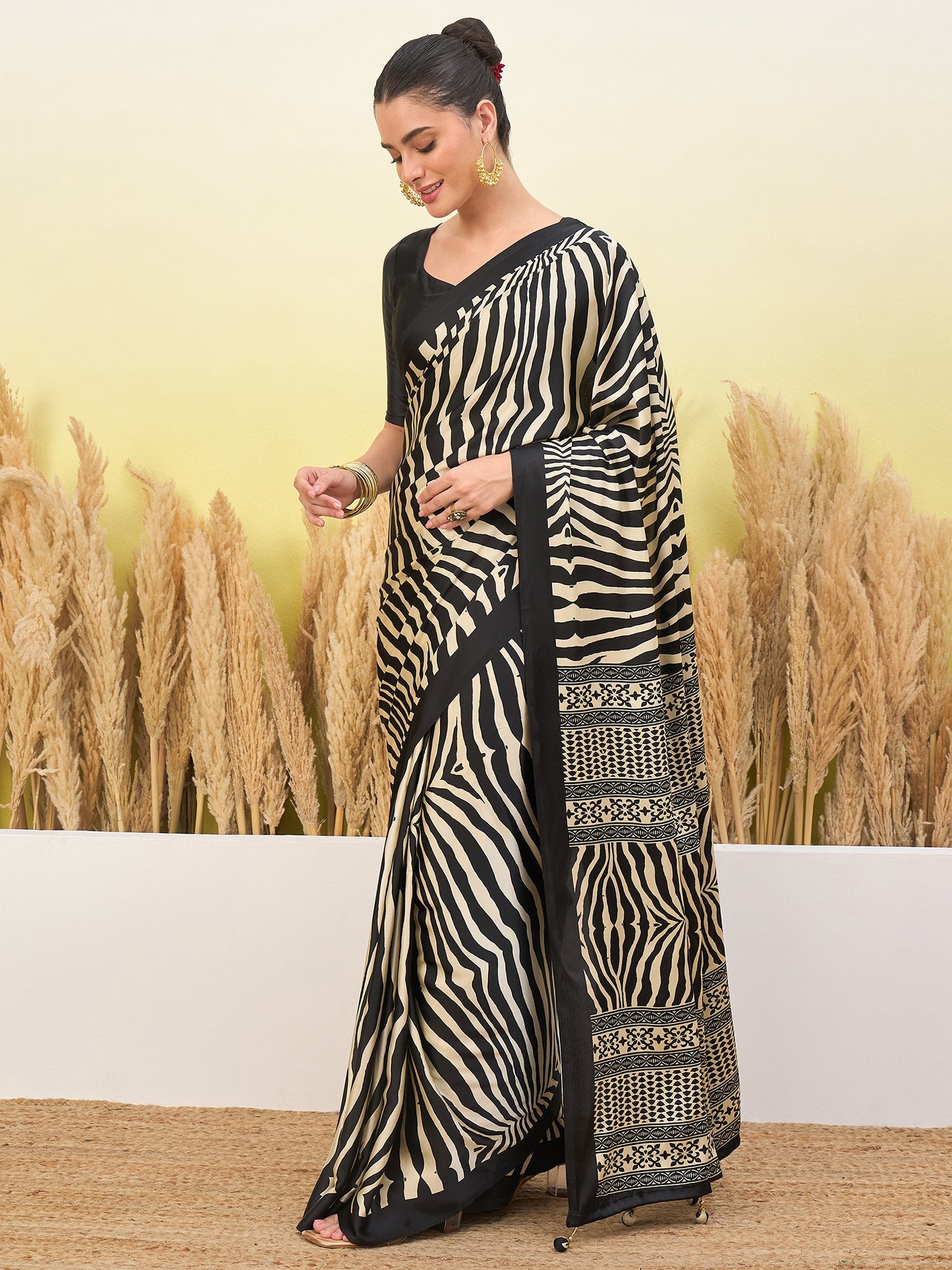 Black crepe silk easy saree with flowing zebra stripes and ornate border section