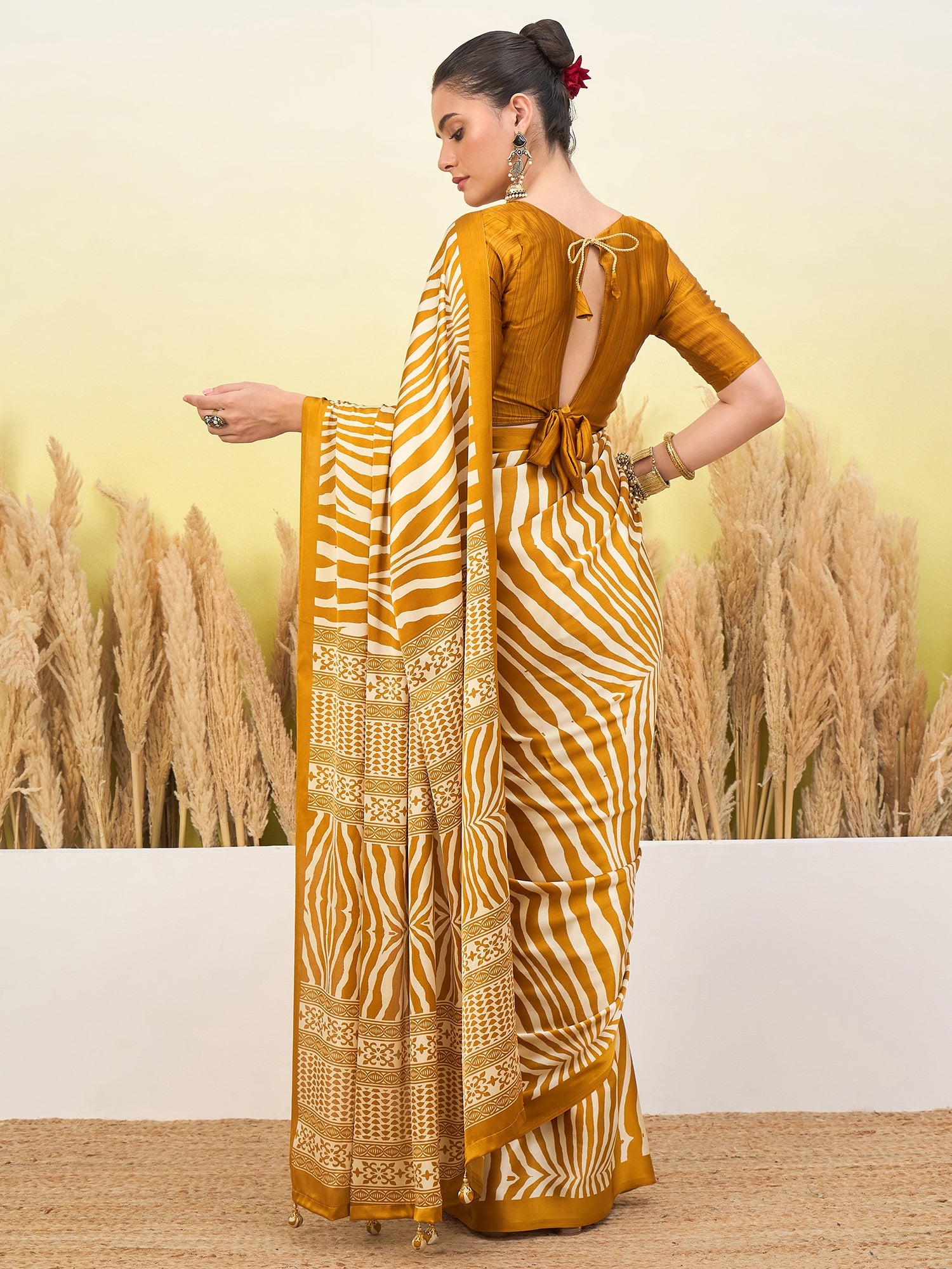 Mustard yellow ready saree, white zebra stripes, open back blouse with tied belt