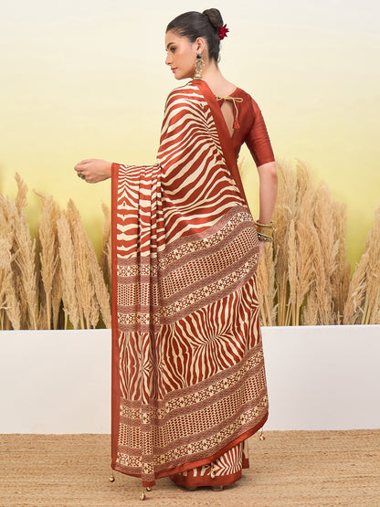 Rust-orange and cream zebra-striped saree with gold border and pleated drape