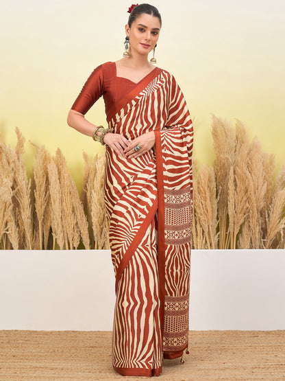 Rust-orange zebra-striped saree with gold border and short-sleeve blouse, standing