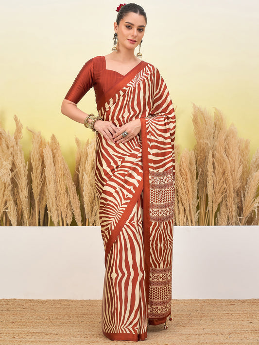 Rust-orange zebra-striped saree with gold border and short-sleeve blouse, standing