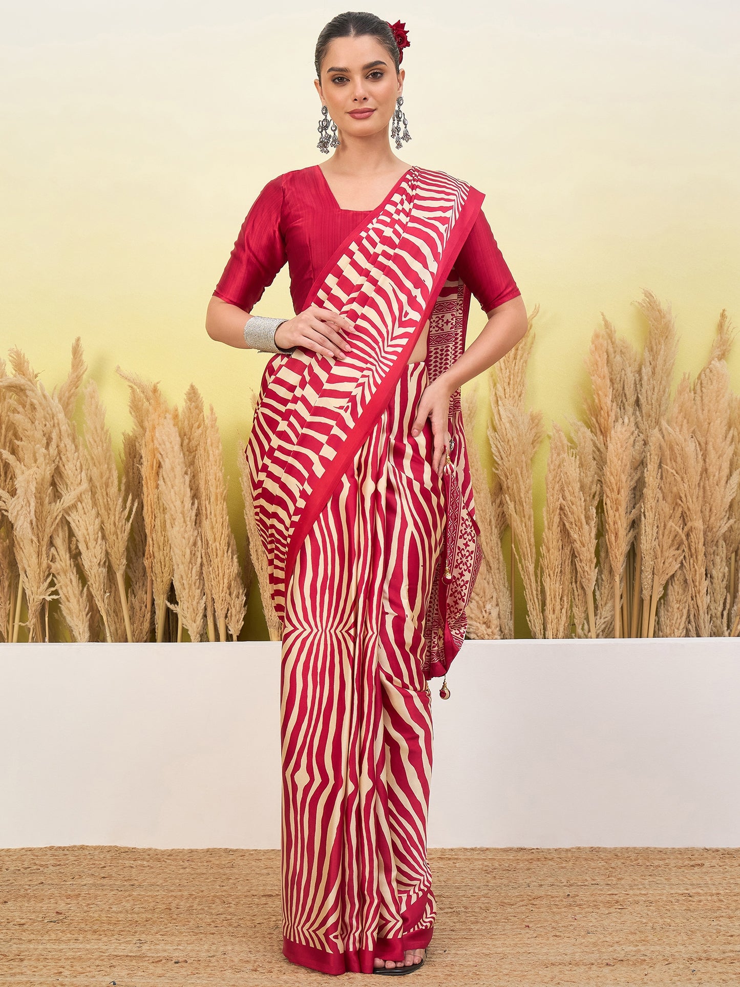 Red sari with white zigzag drape and gold embellished border, with 3/4 sleeve blouse