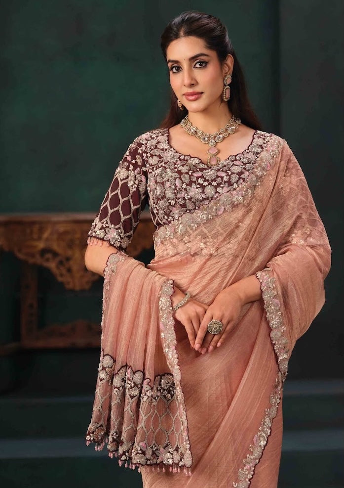 Peach saree drape with embroidered edging and maroon floral pre-stitched blouse