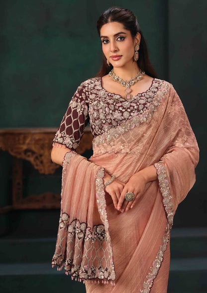 Peach saree drape with embroidered edging and maroon floral pre-stitched blouse