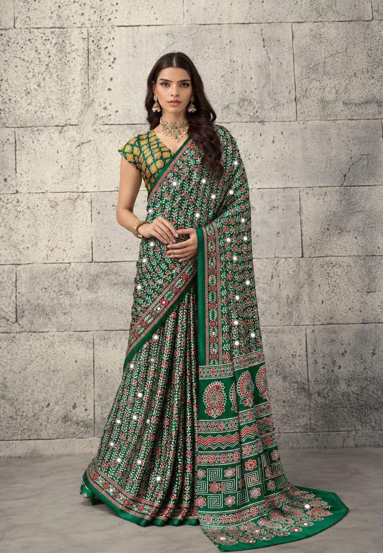 Green crepe-silk saree with red mirror dots, patterned border and drape, ready to wear