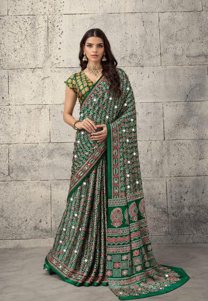 Green crepe-silk saree with red mirror dots, patterned border and drape, ready to wear