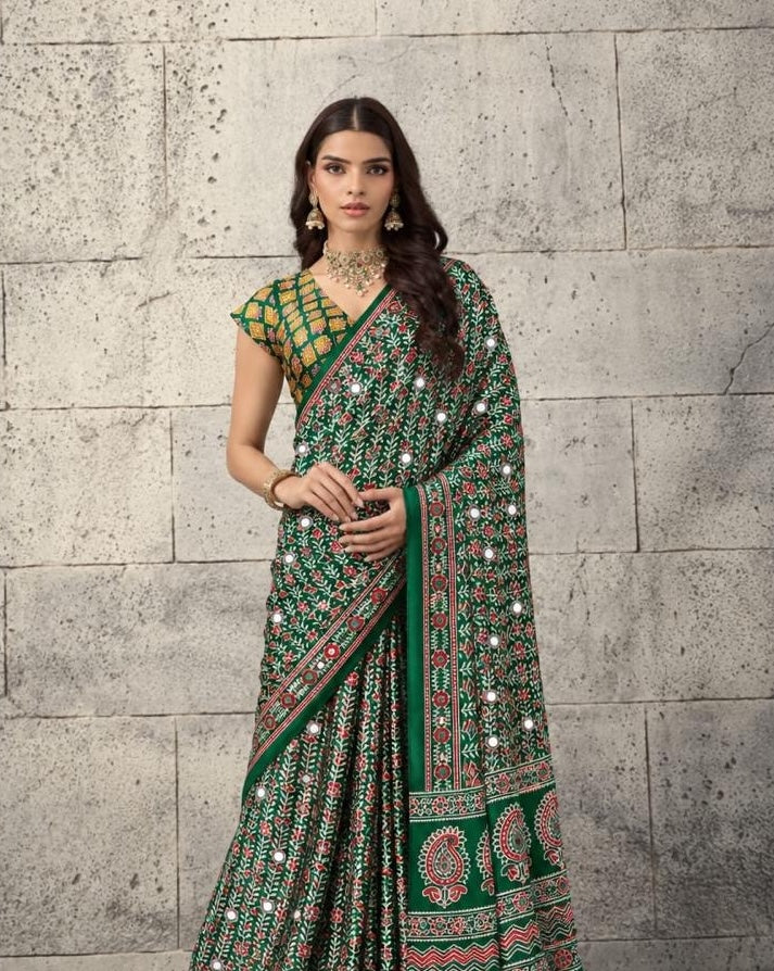Green crepe-silk saree with red mirror dots and woven motifs, single-pallu drape