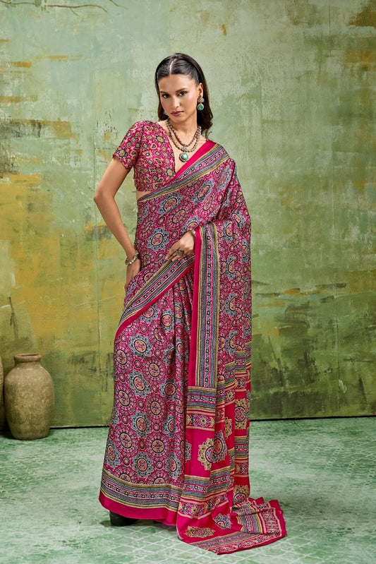 Pink modal silk saree draped on model with short sleeves, paisley print, and gold border