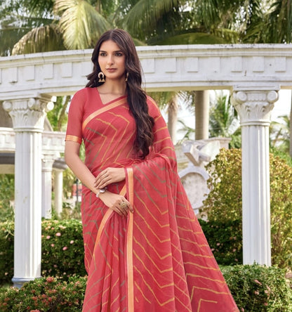 Coral pink georgette saree close-up with gold-line design and wide border