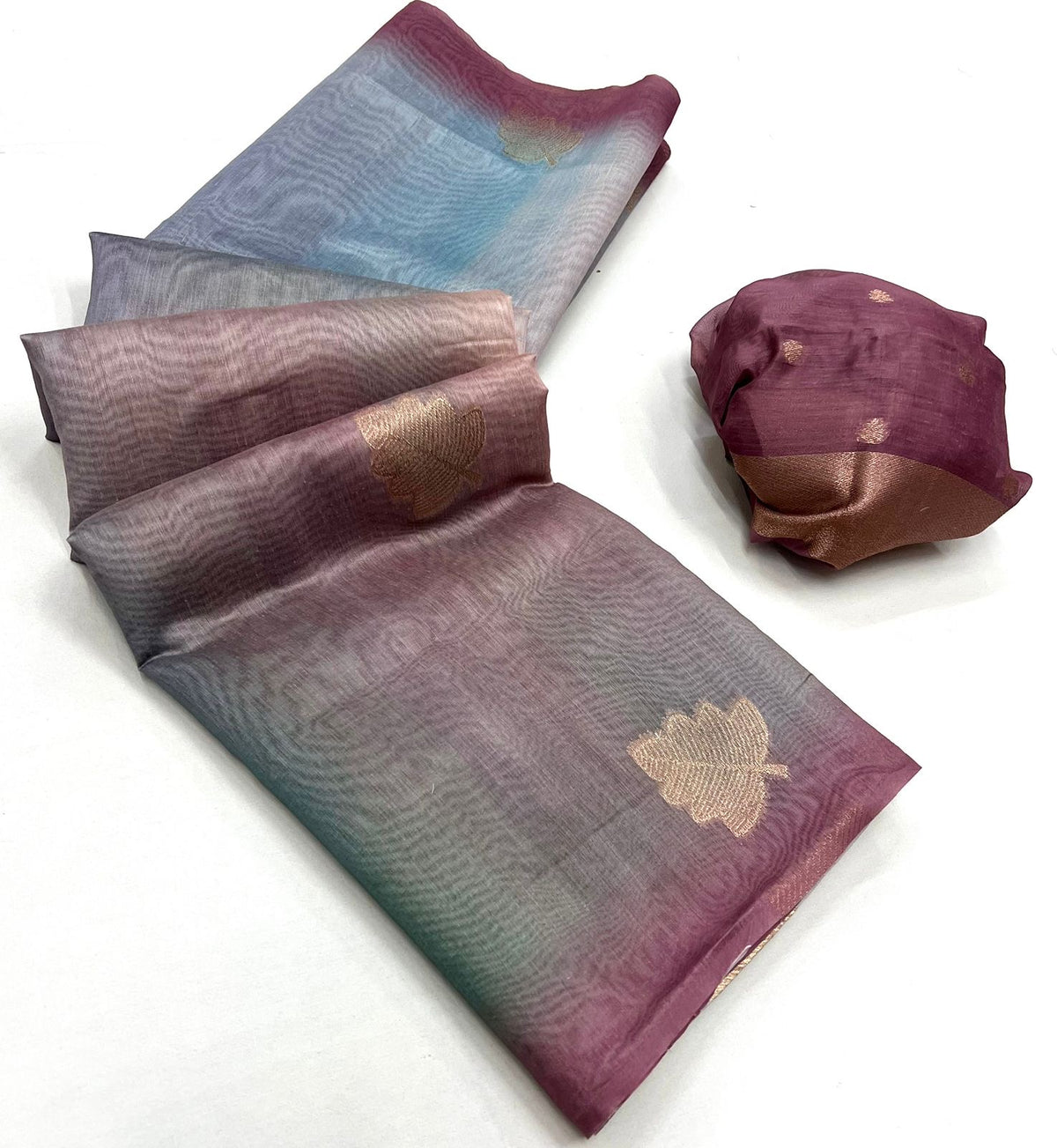 Mauve pink and blue printed linen saree with floral motifs, folded drape