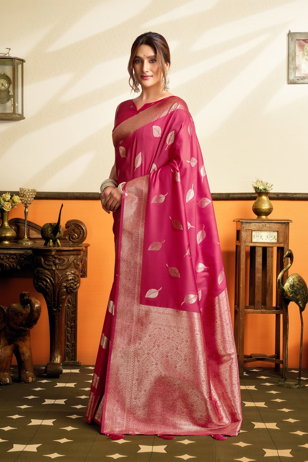 Pink ready-to-wear silk saree with ornate gold border and repeating leaf pattern, full drape