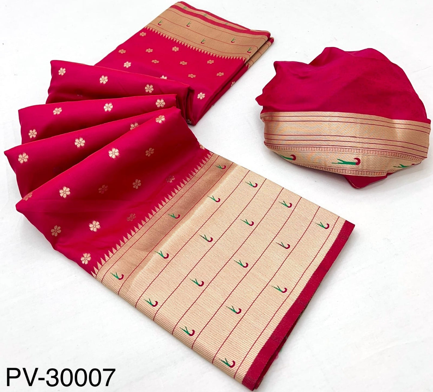 Folded red and beige Paithani silk saree with gold border and scattered floral motifs