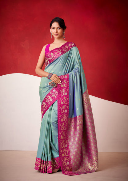 Teal satin silk saree with magenta embroidered border and draped pallu