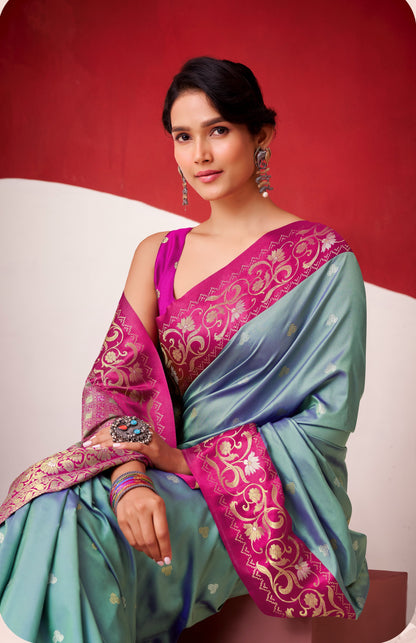 Teal satin silk saree with magenta blouse panel and ornate border