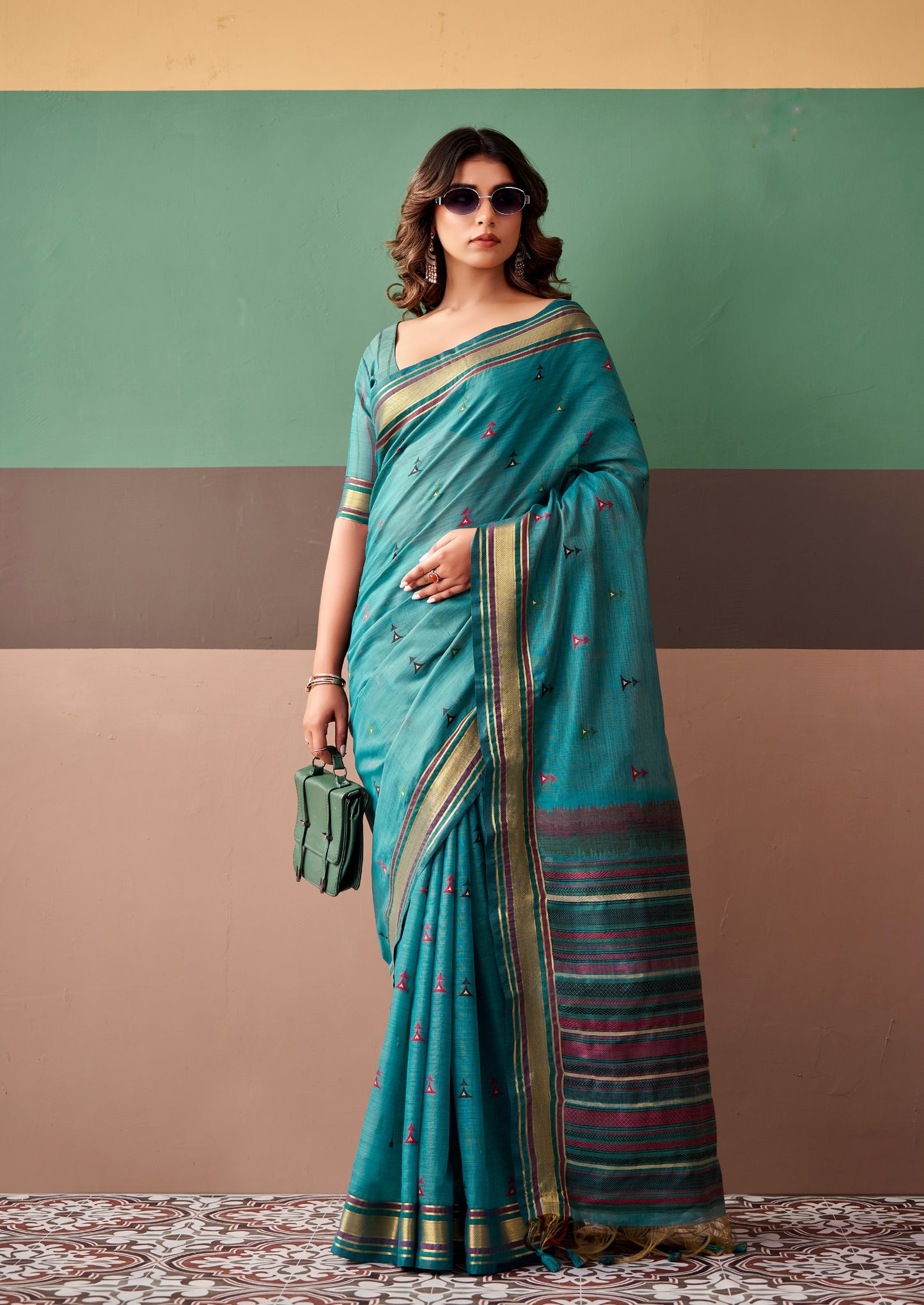 Ready-to-wear teal saree with small printed motifs and striped multicolor border