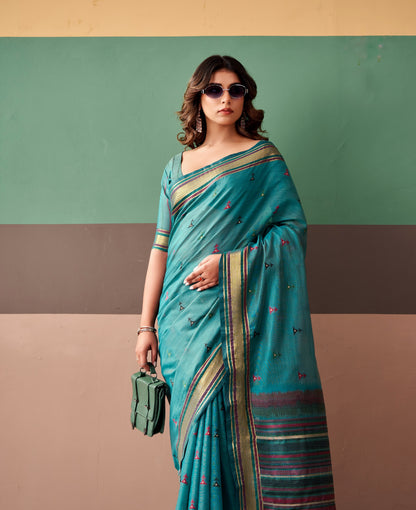Ready-to-wear teal saree draped at shoulder with striped border and small prints