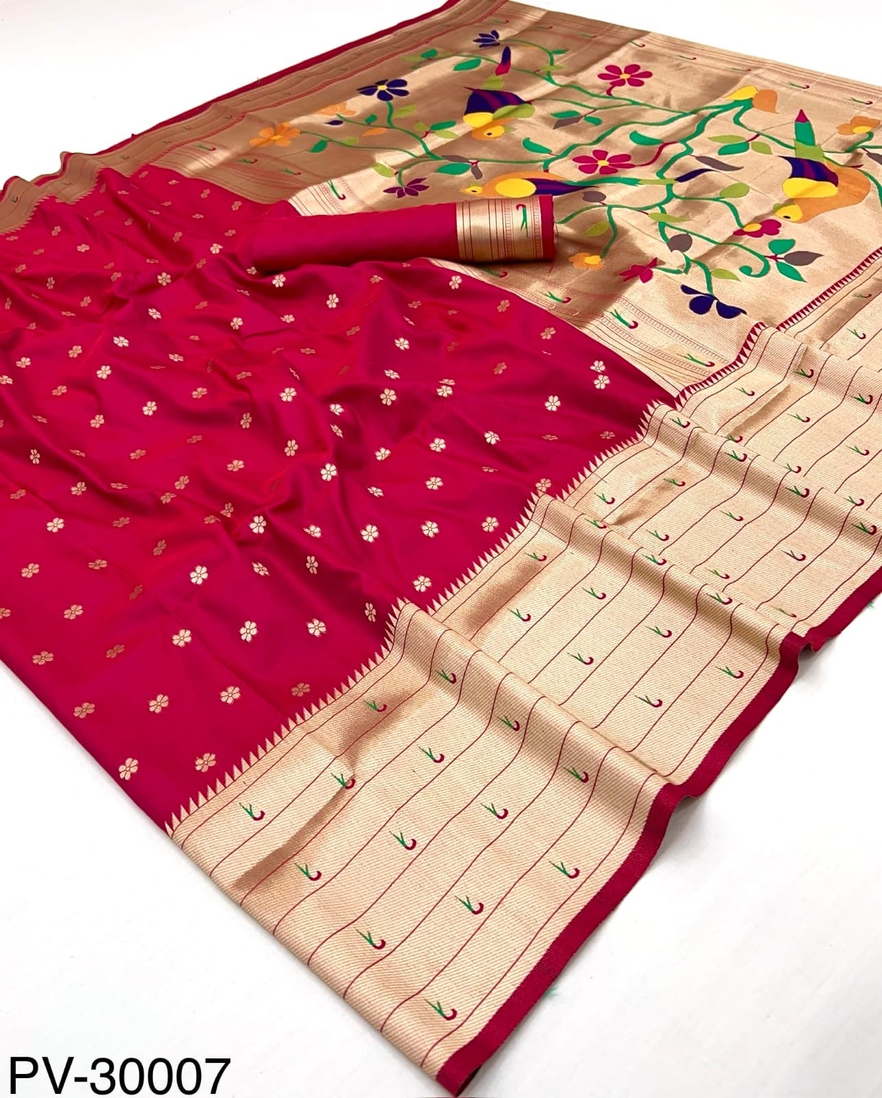 Folded red and beige Paithani silk saree with gold zari border and floral print pallu