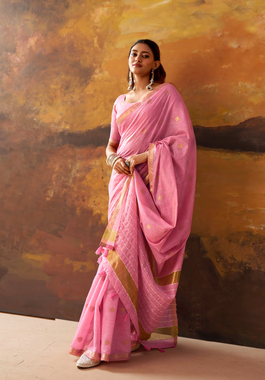 Pink ready-to-wear saree with draped pallu, patterned border, and dotted motif