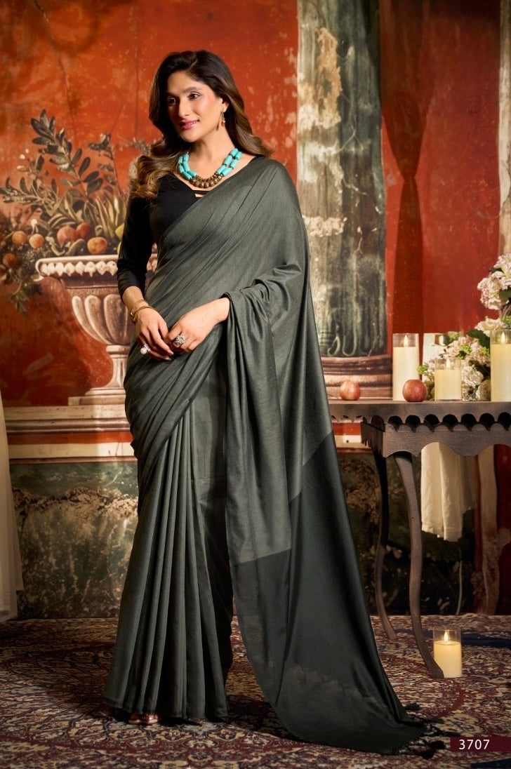Charcoal grey and black cotton saree draped with long pleats and matching blouse