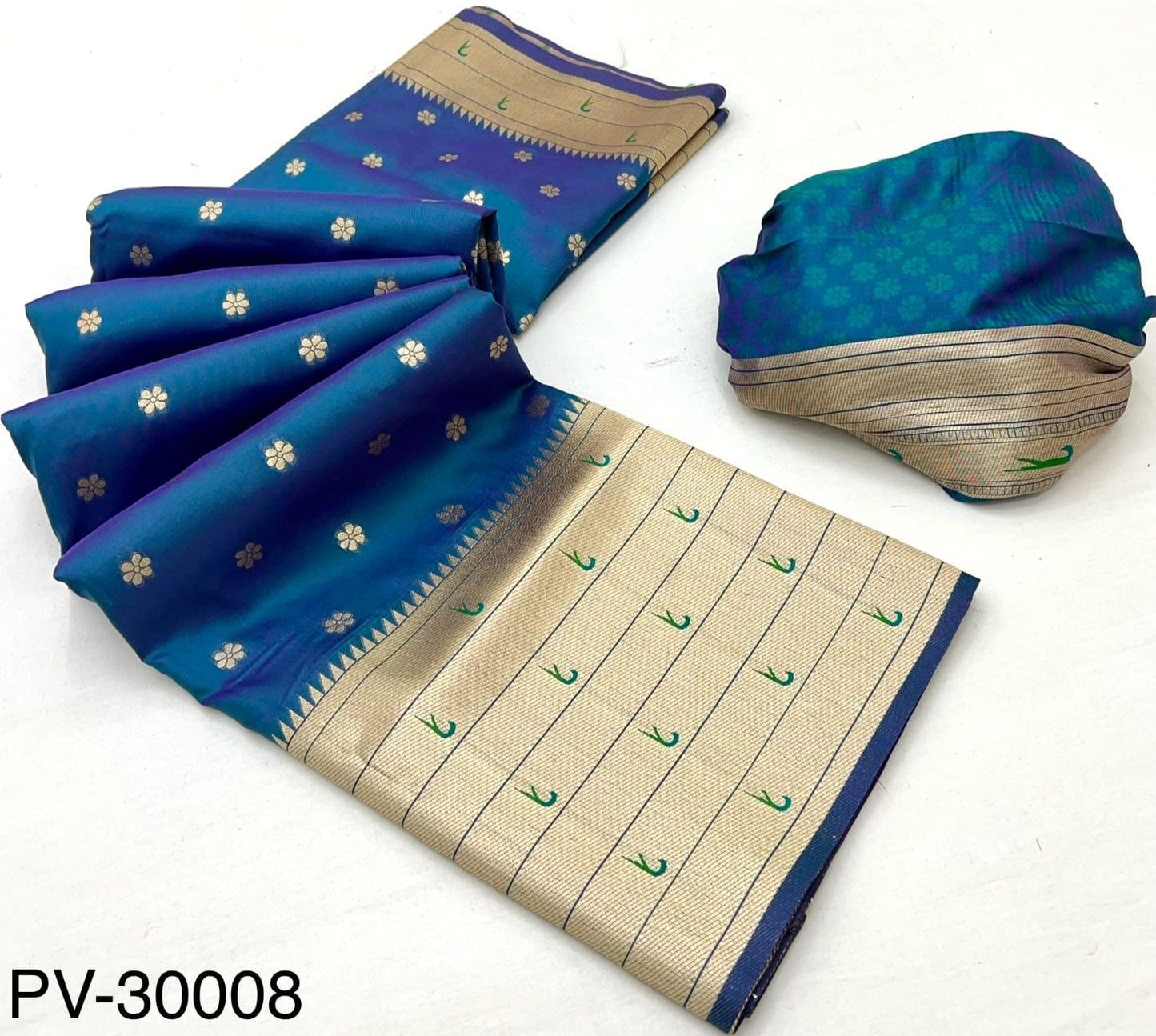 Folded blue saree fabric with beige panel, gold accents and decorative motifs