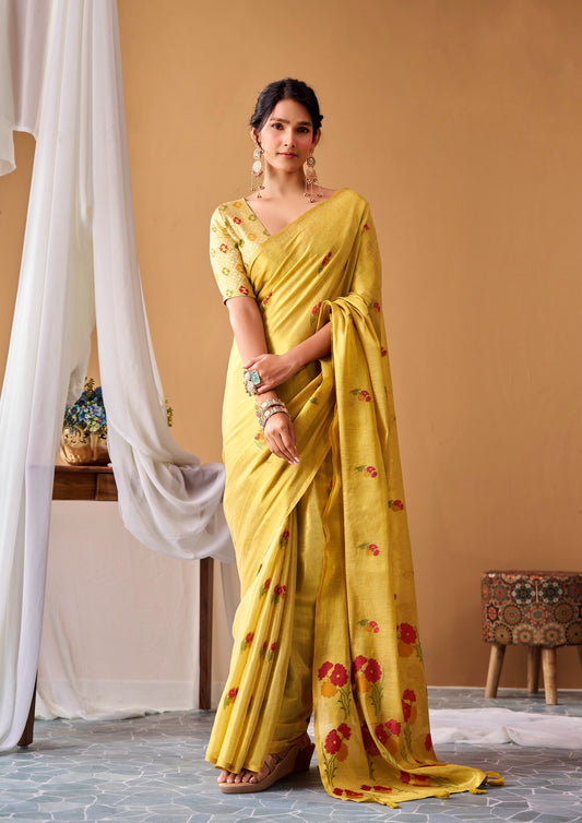 Light yellow tissue silk saree with floral border, draped over short-sleeve blouse