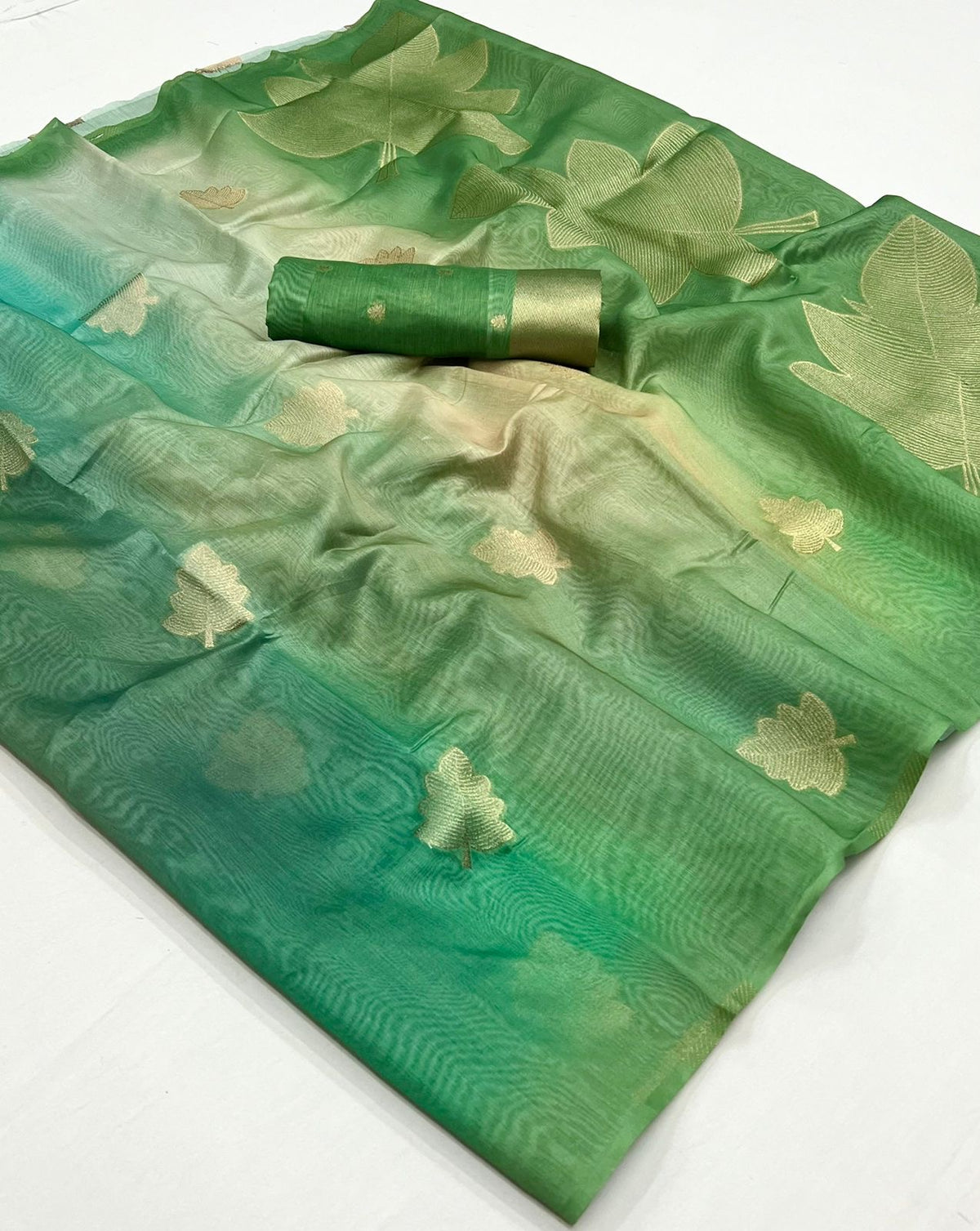 Green linen saree, all-over gold clover/flower motif print, neatly folded