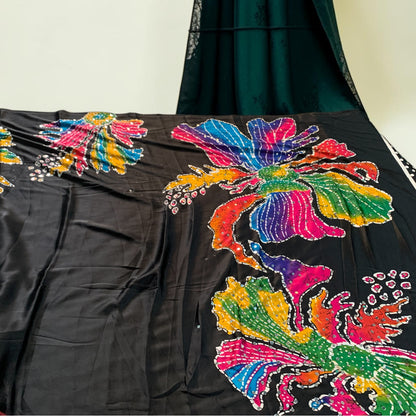 Black saree fabric close-up with vibrant multicolor floral-butterfly embroidery and sequins
